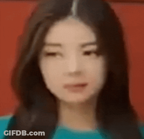 A Close Up Of A Woman 'S Face With A Blurry Background GIF