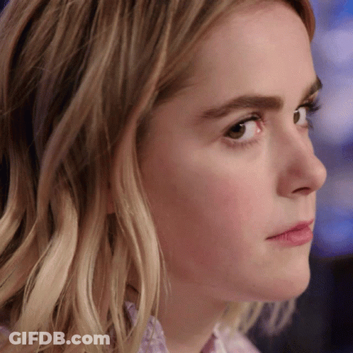 A Close Up Of A Woman 'S Face With A Brown Eye GIF