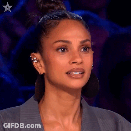 Close Up Of Woman's Face With Bun And Earrings GIF