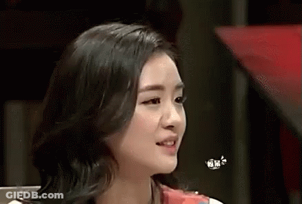 A Close Up Of A Woman 'S Face With A Butterfly Flying Over Her Head . GIF