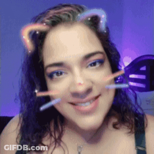 A Close Up Of A Woman 'S Face With A Cat Ear Filter On GIF