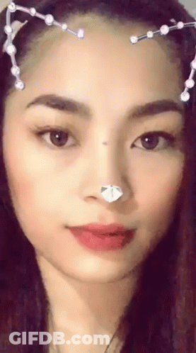 A Close Up Of A Woman 'S Face With A Cat Ear Headband . GIF
