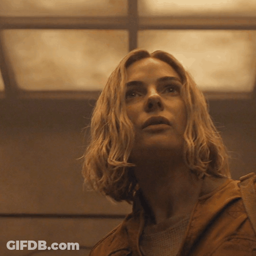 A Close Up Of A Woman 'S Face With A Ceiling In The Background GIF