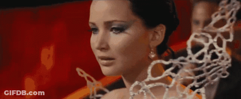 A Close Up Of A Woman 'S Face With A Chain Around Her Neck . GIF