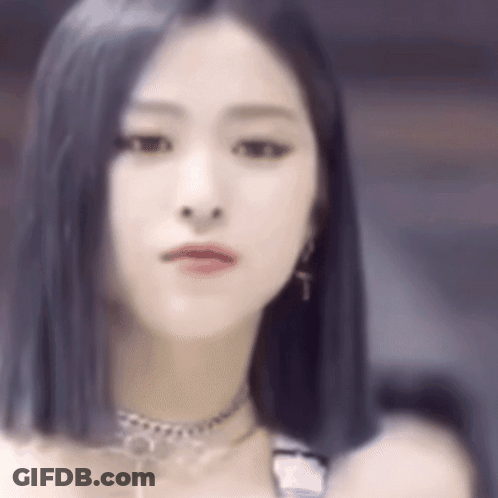 A Close Up Of A Woman 'S Face With A Choker And Earrings . GIF