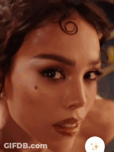 A Close Up Of A Woman 'S Face With A Circle On Her Head GIF