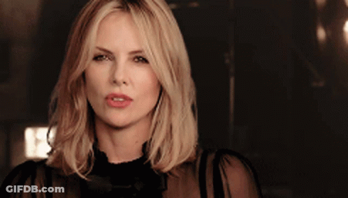 A Close Up Of A Woman 'S Face With A Dark Background GIF