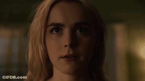 A Close Up Of A Woman 'S Face With A Dark Background . GIF