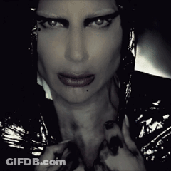 A Close Up Of A Woman 'S Face With A Dark Background GIF