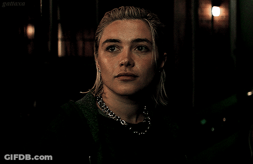A Close Up Of A Woman 'S Face With A Dark Background And The Word Gatiaxa On The Bottom Right GIF
