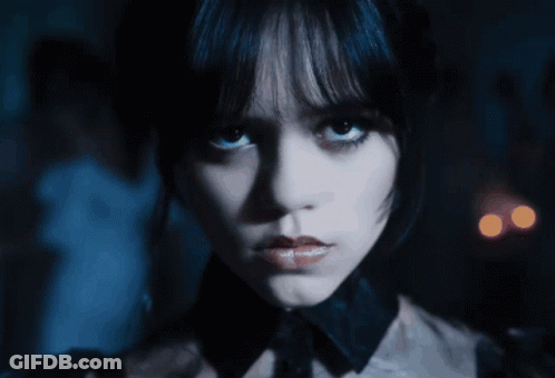 A Close Up Of A Woman 'S Face With A Dark Background GIF