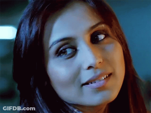 A Close Up Of A Woman 'S Face With A Dark Background GIF