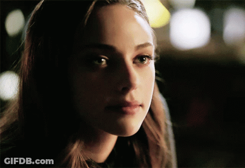 A Close Up Of A Woman 'S Face With A Dark Background GIF