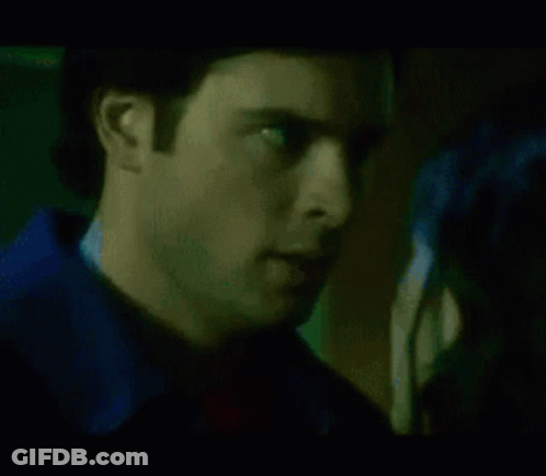 A Close Up Of A Woman 'S Face With A Green And Blue Light Behind Her GIF