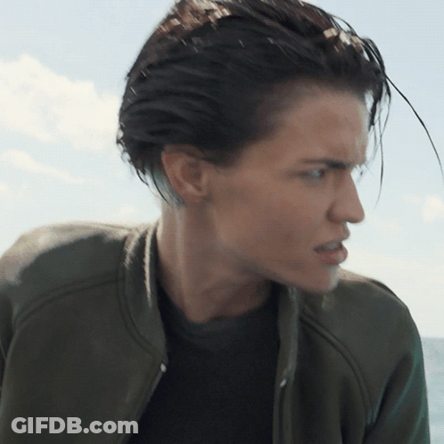 A Close Up Of A Woman 'S Face With A Green Jacket GIF