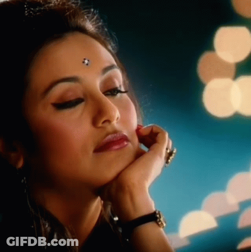 A Close Up Of A Woman 'S Face With A Hand On Her Chin GIF