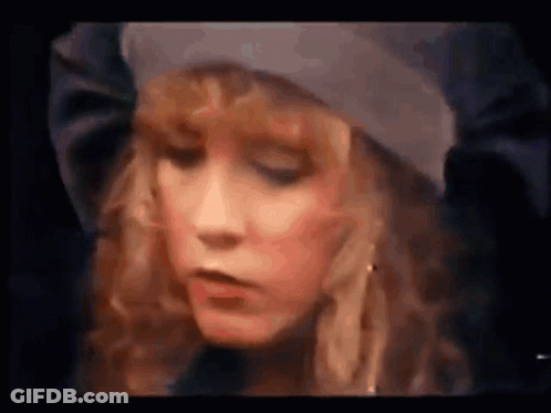 A Close Up Of A Woman 'S Face With A Hat On . GIF