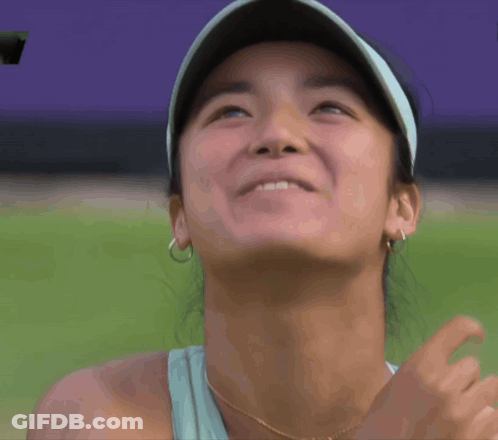 A Close Up Of A Woman 'S Face With A Hat On GIF