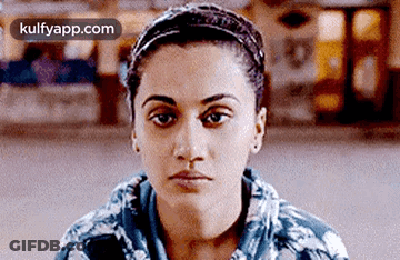 A Close Up Of A Woman 'S Face With A Headband Around Her Head . GIF