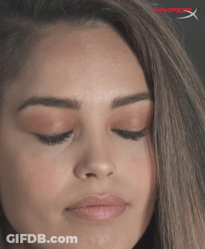 A Close Up Of A Woman 'S Face With A Hyperx Logo In The Corner GIF