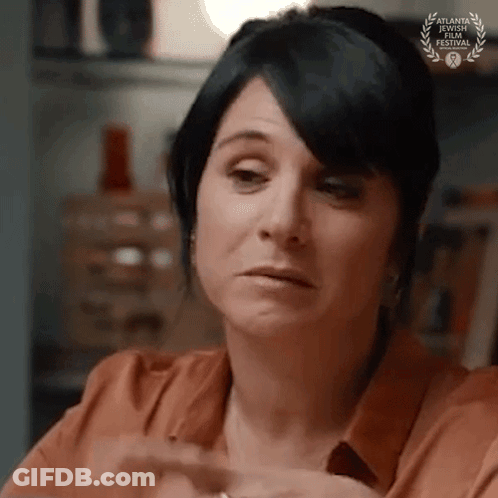 A Close Up Of A Woman 'S Face With A Laurel Wreath On Her Forehead . GIF