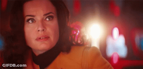 A Close Up Of A Woman 'S Face With A Light Coming Out Of Her Mouth . GIF