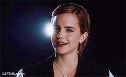 A Close Up Of A Woman 'S Face With A Light Shining On Her Face GIF