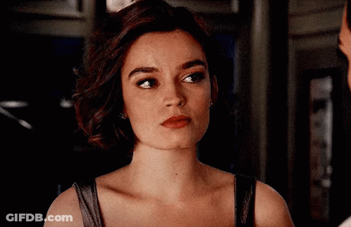 A Close Up Of A Woman 'S Face With A Man Behind Her . GIF