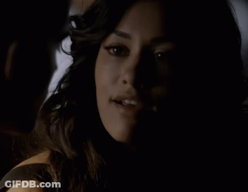 A Close Up Of A Woman 'S Face With A Man Behind Her GIF
