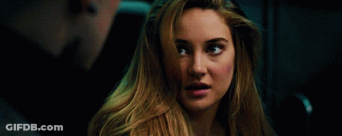 A Close Up Of A Woman 'S Face With A Man In The Background . GIF