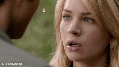A Close Up Of A Woman 'S Face With A Man 'S Face In The Background GIF