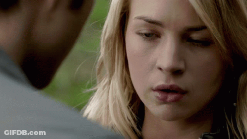 A Close Up Of A Woman 'S Face With A Man 'S Face In The Background GIF
