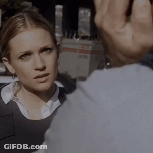 A Close Up Of A Woman 'S Face With A Man 'S Hand Behind Her GIF