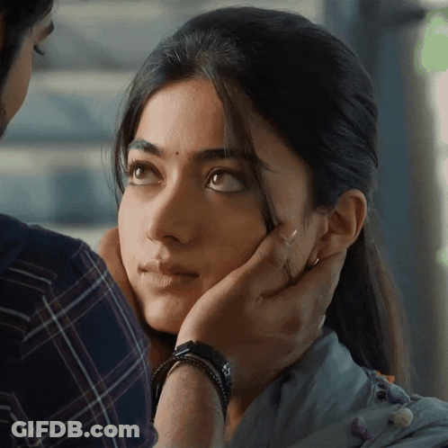 A Close Up Of A Woman 'S Face With A Man 'S Hand On Her Forehead GIF