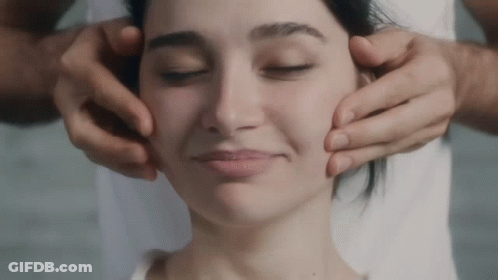 A Close Up Of A Woman 'S Face With A Man 'S Hands On It GIF