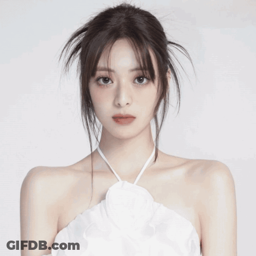 A Close Up Of A Woman 'S Face With A Messy Hairdo And Red Lips . GIF