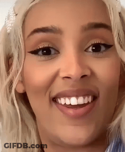 A Close Up Of A Woman 'S Face With A Missing Tooth GIF