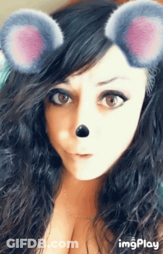 A Close Up Of A Woman 'S Face With A Mouse Mask On GIF