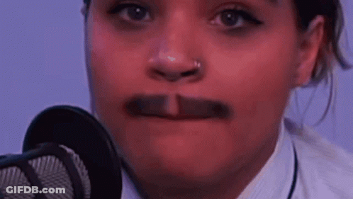 A Close Up Of A Woman 'S Face With A Mustache . GIF