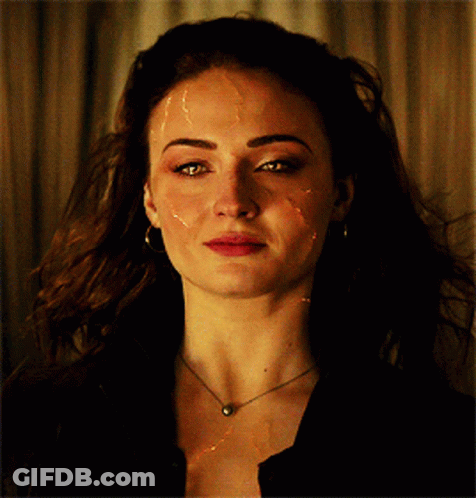 A Close Up Of A Woman 'S Face With A Necklace And Earrings GIF