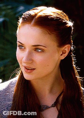 A Close Up Of A Woman 'S Face With A Necklace Around Her Neck GIF