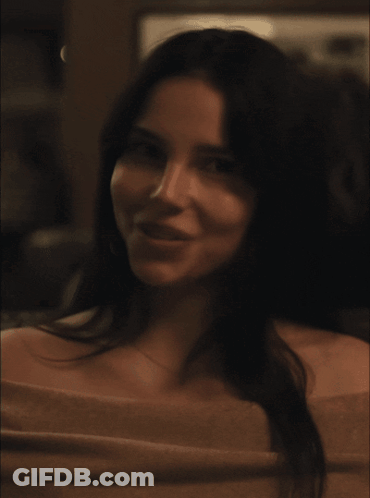 A Close Up Of A Woman 'S Face With A Necklace On GIF