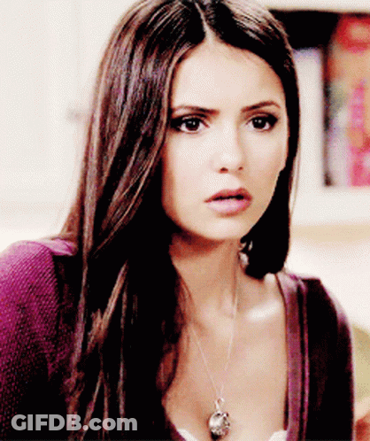 A Close Up Of A Woman 'S Face With A Necklace On Her Neck GIF