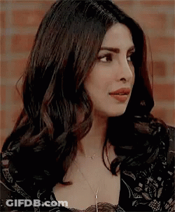 A Close Up Of A Woman 'S Face With A Necklace On . GIF