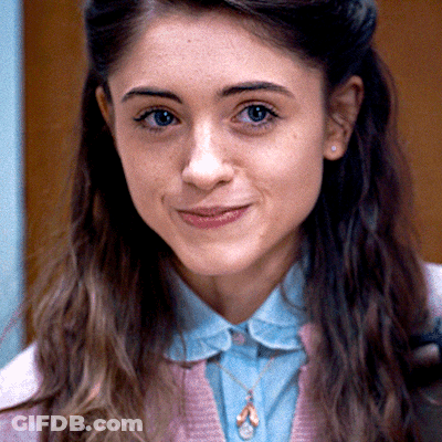 A Close Up Of A Woman 'S Face With A Necklace On GIF