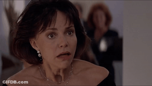 A Close Up Of A Woman 'S Face With A Necklace On GIF