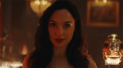A Close Up Of A Woman 'S Face With A Necklace On . GIF