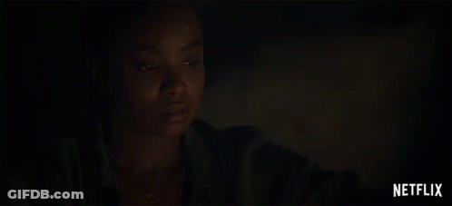 A Close Up Of A Woman 'S Face With A Netflix Logo Behind Her GIF