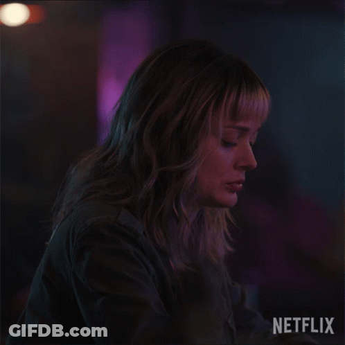 A Close Up Of A Woman 'S Face With A Netflix Logo Behind Her GIF