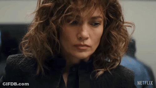 Close Up Of Woman's Face With Netflix Logo Behind GIF